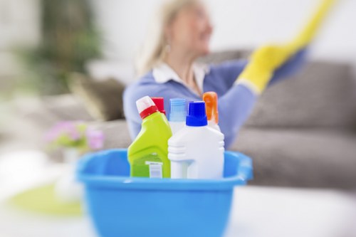 Cleaning operative handling carpet cleaning chemicals with care